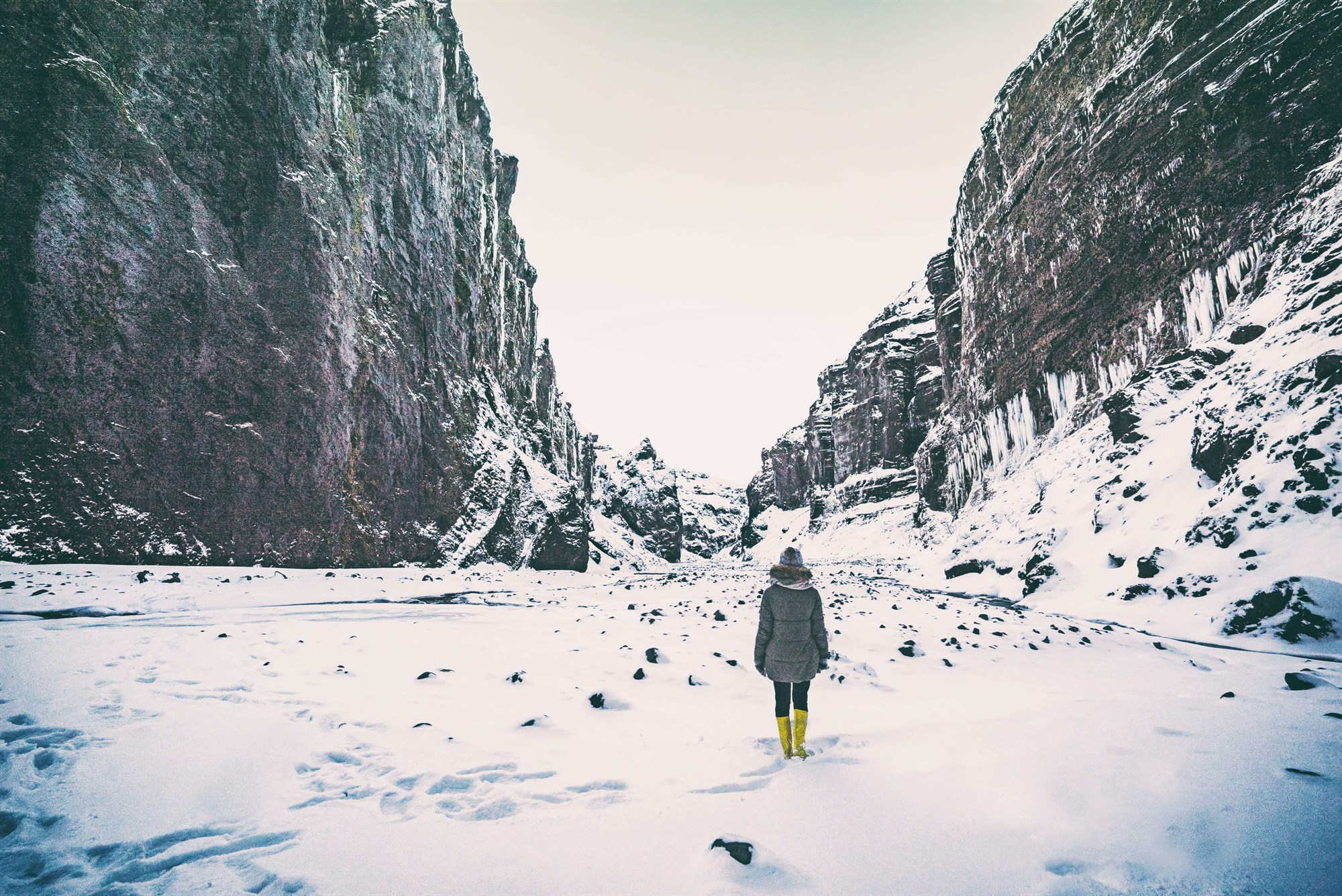 Person hiking in the snow at Stakkholtsgjá canyon